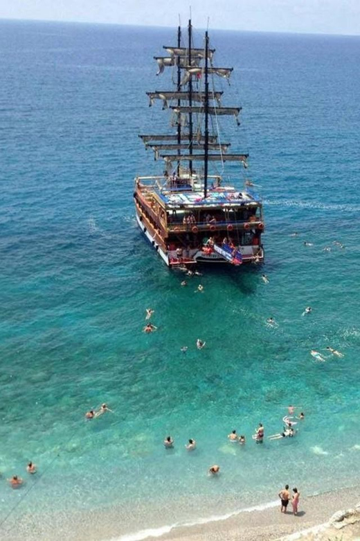 Alanya: Catamaran Boat Tour with Snorkeling with Lunch - Leaving Alanya Harbor with the castle behind you