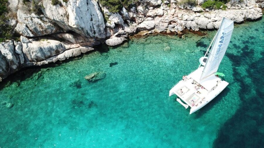 Alghero: Full day on a catamaran in Porto Conte Natural Park - Seeing Capo Caccia from Porto Conte Bay