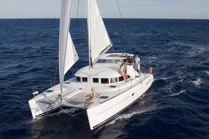 Catamaran Day & Sunset Cruises with meals Drinks and transportation - Sailing past Baos and stopping near Delos