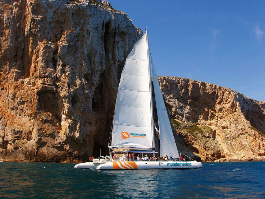 Dénia & Jávea: Portixol Sailing Catamaran Excursion with BBQ - The Dénia coastline from the water