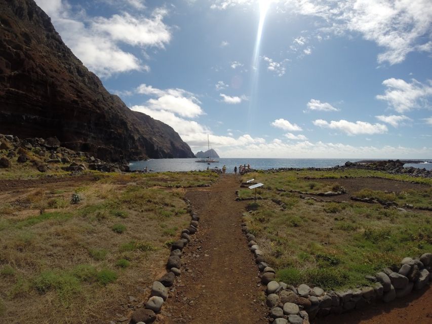 Desertas Islands Full-Day Catamaran Trip from Funchal - Swimming, snorkeling, and paddleboarding beside volcanic rock