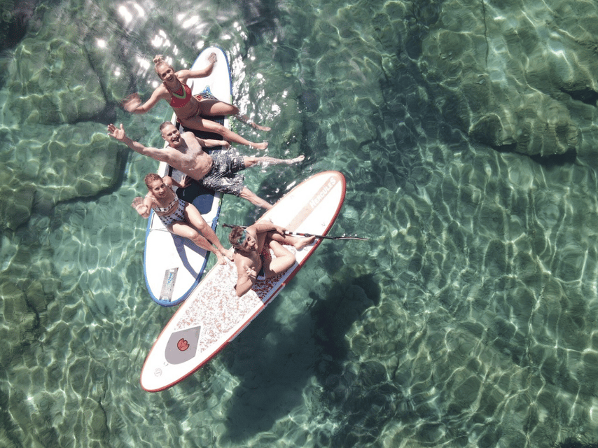 From Ornos: Mykonos Delos Catamaran Cruise with Meal & SUP - Rhenia’s clear water and quiet cove