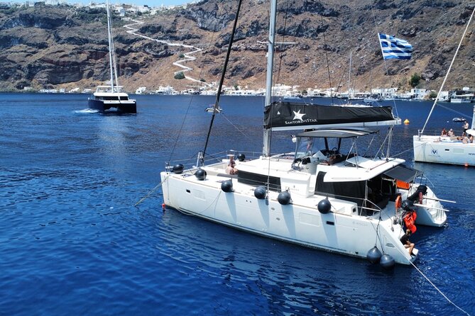Half Day Premium Catamaran Cruise in Santorini including Oia - Red Beach gives you the first swim