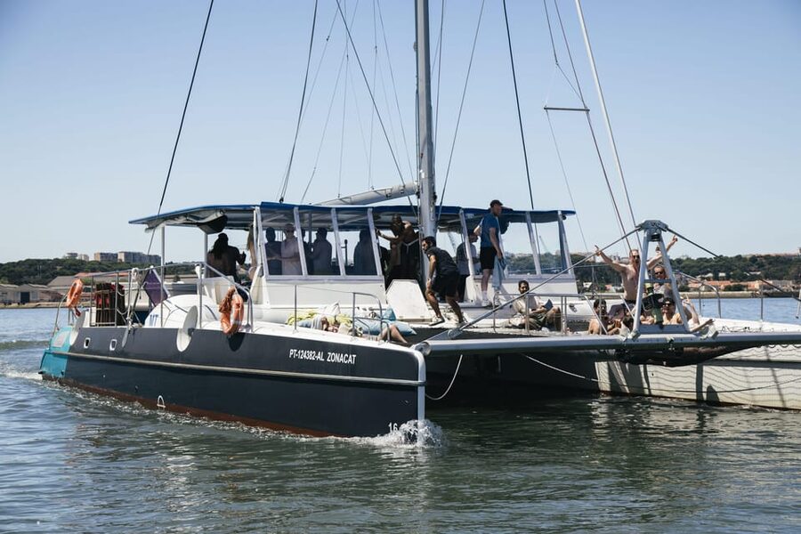 Lisbon: Catamaran Boat Party with Music, Open Bar & Dives - Finding Doca de Santo Amaro in Alcântara