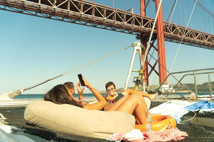 Lisbon: Catamaran Boat Party with Music, Open Bar & Dives - Belém Tower From the Water