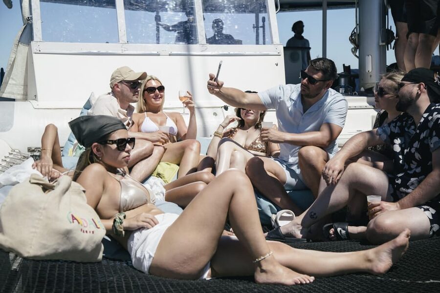 Lisbon: Catamaran Boat Party with Music, Open Bar & Dives - The 25 de Abril Bridge and the Wide River View