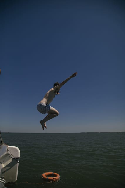 Lisbon: Catamaran Boat Party with Music, Open Bar & Dives - Music, Dancing, and the Onboard Mood