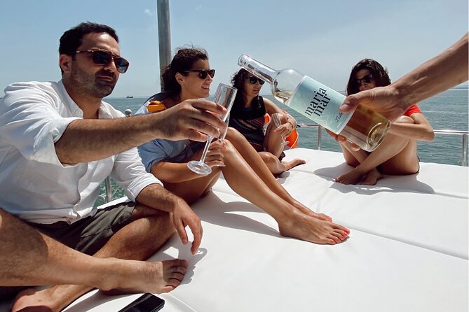 Lisbon: Catamaran Luxury Sunset and Wine Tour - Cristo Rei and the south bank