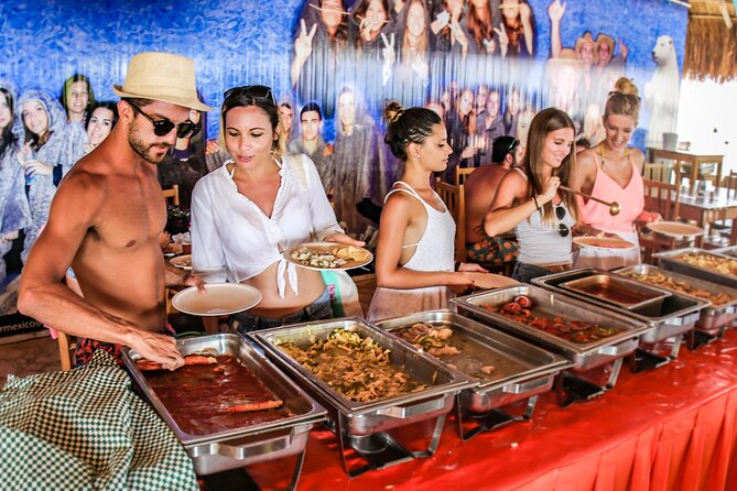 Live this unique experience. Catamaran to Isla Mujeres Tour. Open Bar included. - Lunch and beach time at a private club