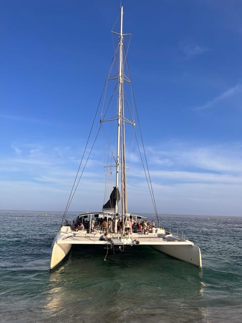 Lloret de Mar: Sunset Catamaran Cruise with DJ and Drinks - The Costa Brava shoreline from the water
