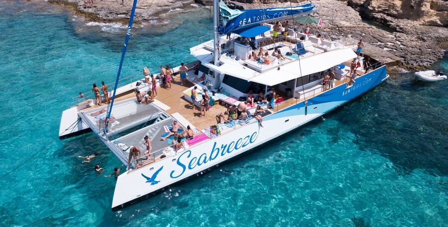 Malta: Blue Lagoon Evening Catamaran Cruise - Anchor Bay and Popeye Village from the water