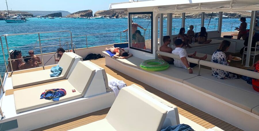 Malta: Blue Lagoon Evening Catamaran Cruise - Swimming, sun beds, and life on deck