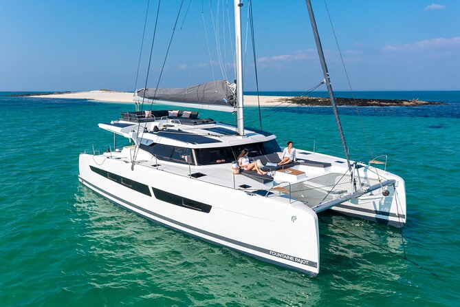 Mykonos: Brand-New Catamaran Cruise with Meal, Drinks & Transport - Rhenia, swim stops, and the southern coast