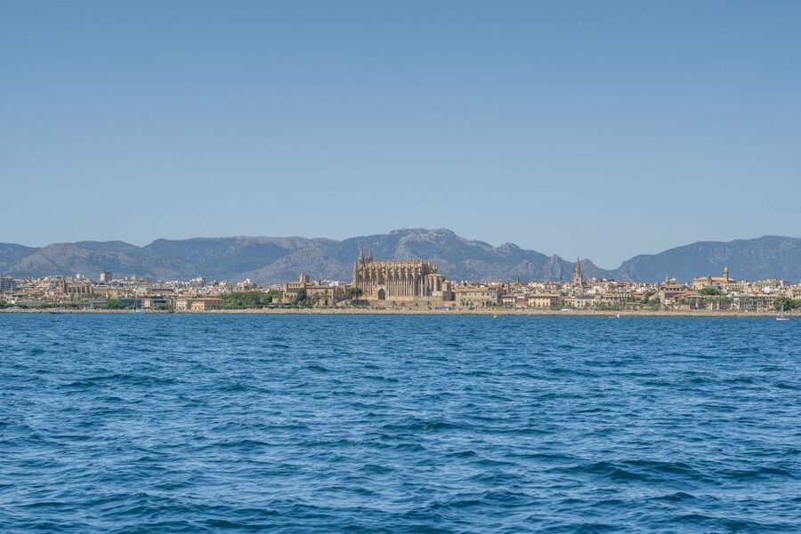 Palma de Mallorca: 5-Hour Catamaran Cruise with Lunch & Swim - Leaving Palma beside yachts and cruise ships