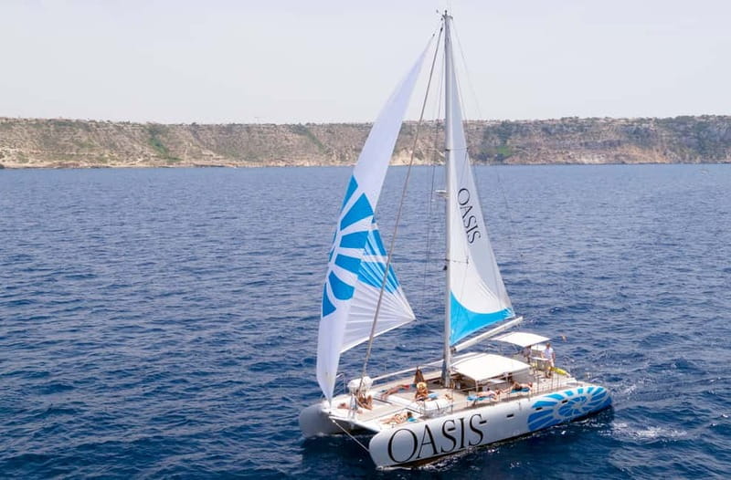 Palma de Mallorca: Deluxe Catamaran Sailing Tour with Meal - Leaving Palma and sailing across the bay