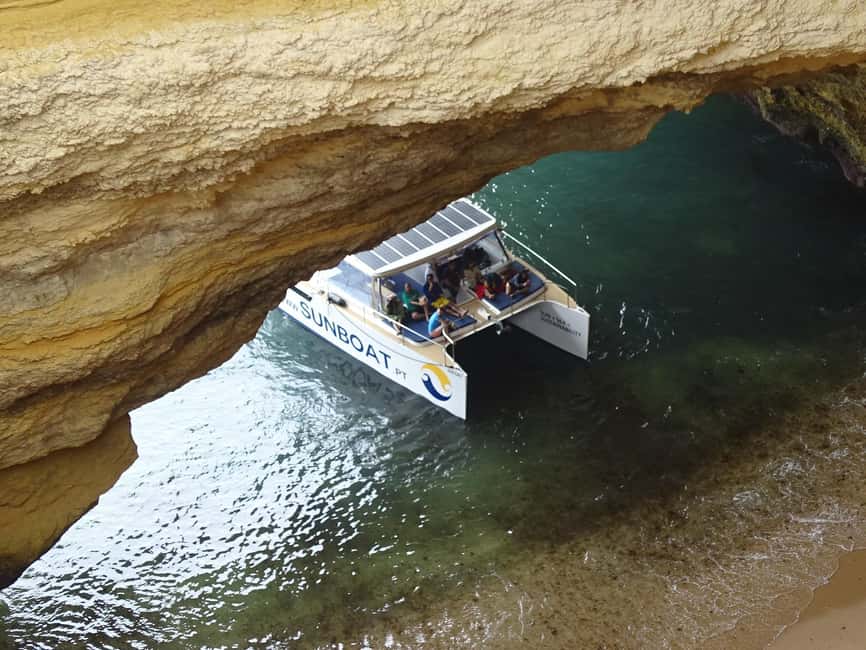 Portimao: SUNSET Benagil Caves Tour | Eco Catamaran - Cruising beside the Algarve cliffs