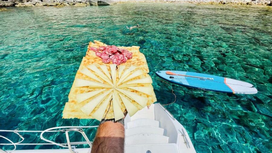 Porto Conte: Sunset catamaran excursion with aperitif - Sunset over the Alghero coast