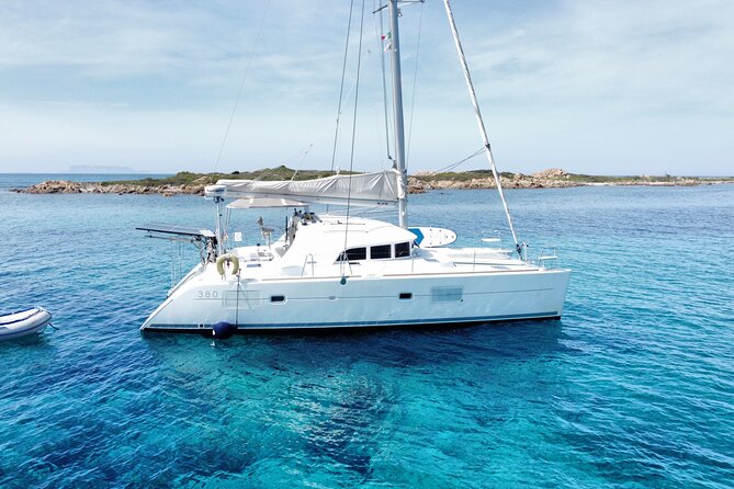 Private catamaran sailing trip around La Caletta -Berchida - Sardinia - Capo Comino brings the clearest beach appeal