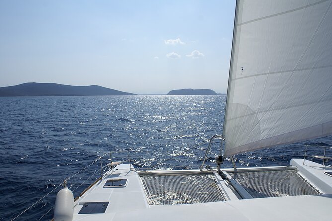 Private Catamaran Tour: Lisbon coast cruise with barbecue and drinks - Leaving Lisbon beneath the bridge