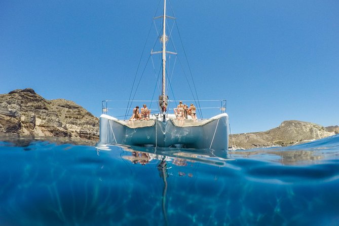 Santorini Catamaran Cruise with Fresh Meal and Open Bar - White Beach and the Akrotiri lighthouse
