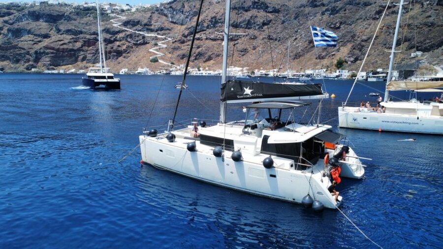 Santorini: Catamaran Cruise with Lunch, Drinks, & Oia Visit - Sunset at Vlychada with a final toast