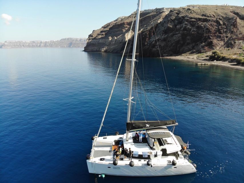 Santorini: Catamaran Cruise with Meal & Open Bar - Indian Rock, Black Mountain, and the sunset finish