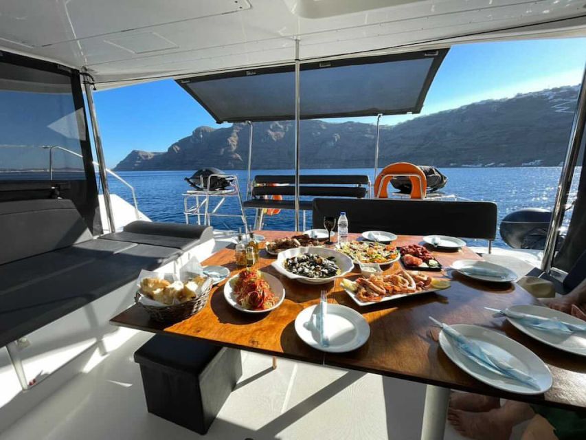 Santorini: Catamaran Cruise with Meal & Open Bar - White Beach and the volcanic coast