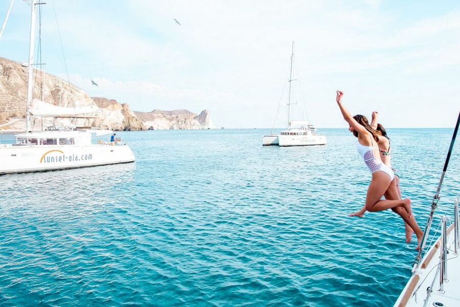 Santorini: Catamaran Tour with BBQ Meal and Unlimited Drinks - White Beach and the onboard BBQ