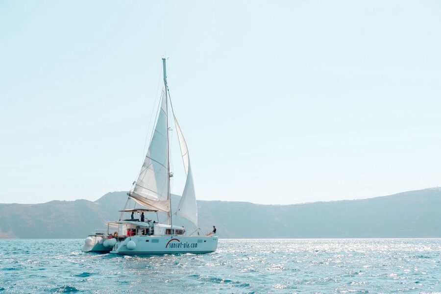 Santorini: Catamaran Tour with BBQ Meal and Unlimited Drinks - Sunset below Oia