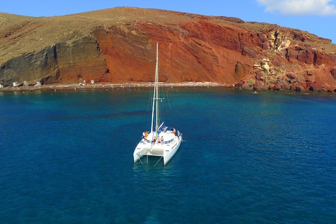 Santorini Full Day Catamaran Private Cruise incl. Meal, Drinks & Free Transport - Akrotiri’s lighthouse and the far southwest coast