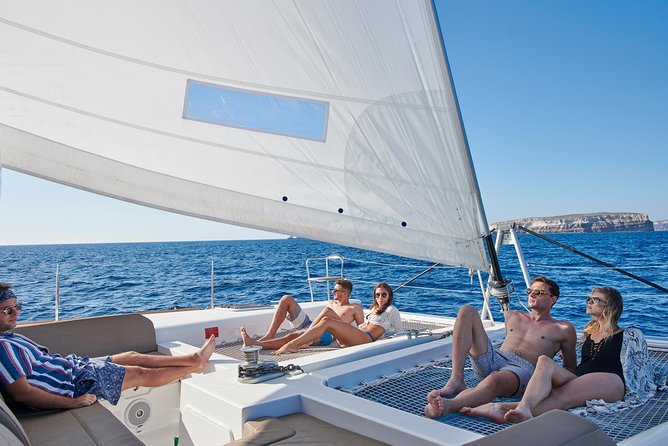 Santorini Gold Catamaran Cruise with BBQ, Drinks and Hotel Pickup - Rough water, motion sickness, and mobility concerns