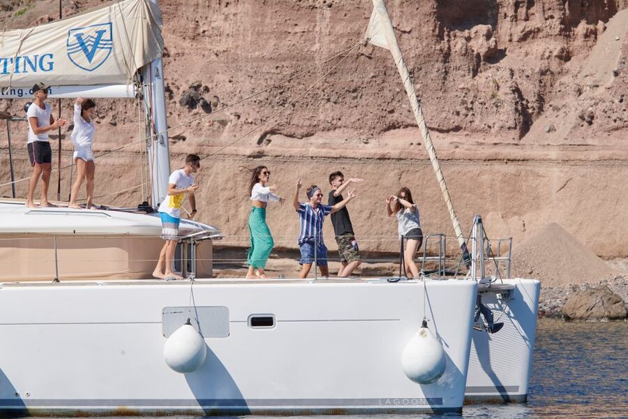 Santorini Gold Catamaran Cruise with Snorkel, BBQ & Open Bar - White Beach, the lighthouse, and volcanic rock