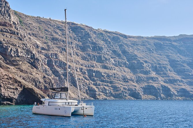 Santorini: Luxury Catamaran Cruise with Fresh Fish BBQ & Drinks - Red Beach: Santorini’s most dramatic shore