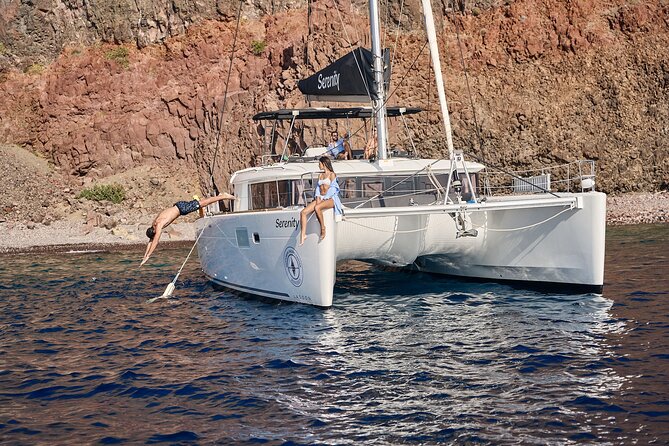 Santorini: Luxury Catamaran Cruise with Fresh Fish BBQ & Drinks - Mesa Pigadia: a quieter black-sand swim