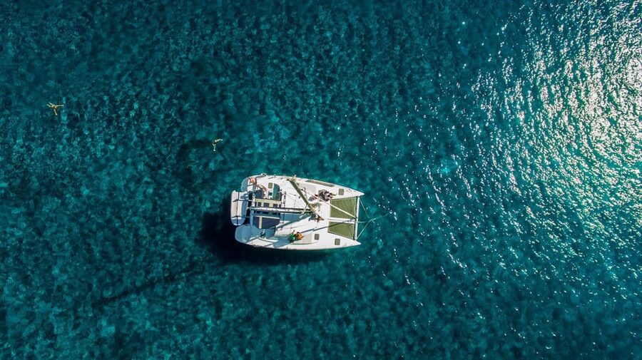Santorini: Private Catamaran Cruise with Food & Drinks - The lighthouse, Indian Rock, and the outer Caldera