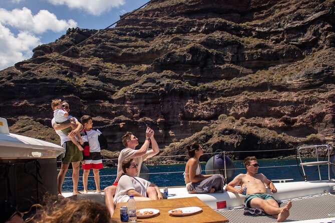 Santorini Sailing Catamaran Daily Cruises w/ Greek BBQ @Thirasia - The Akrotiri lighthouse photo stop